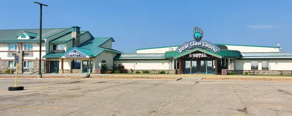 Bear Claw Casino and its hotel wing with green roofs on White Bear First Nations, seen across the empty parking lot