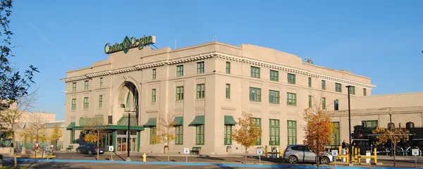 Casino Regina in the former Union Station, a pale stone building with an arched entrance, green awnings and the Casino Regina sign on the roof, on a sunny autumn day